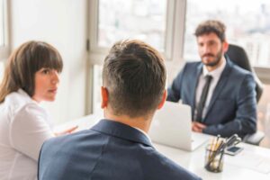 Business meeting between a lawyer and clients discussing legal consultation in an office